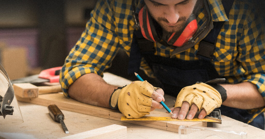 Man marking a piece of wood