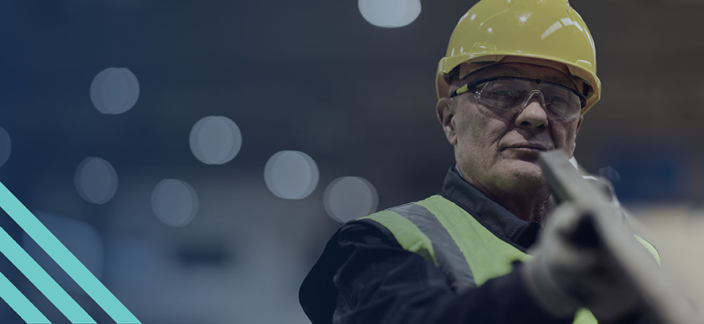 Experienced veteran in safety gear holding construction material